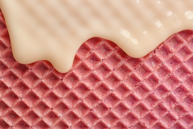 Photo of Hot white chocolate on wafer, closeup. Crispy food