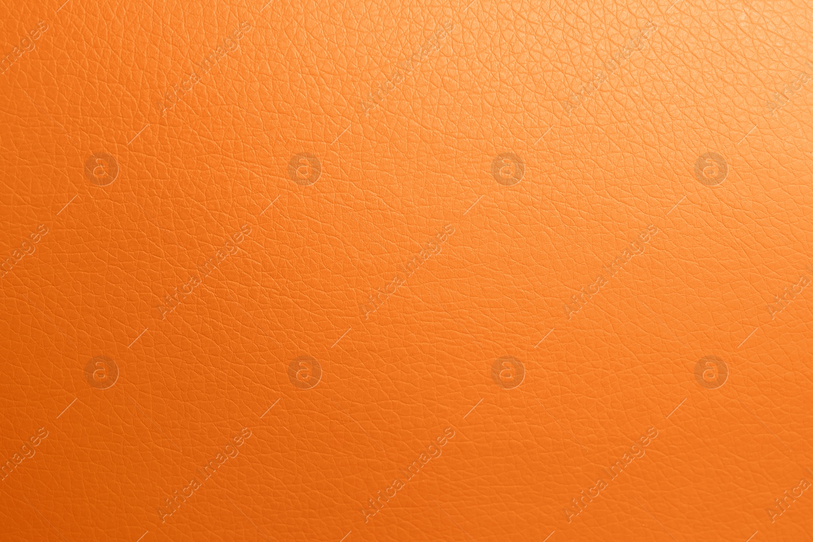 Photo of Texture of orange leather as background, top view