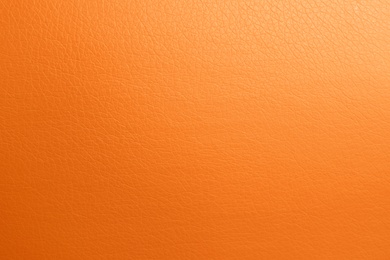 Photo of Texture of orange leather as background, top view