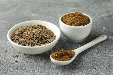 Photo of Caraway (Persian cumin) seeds and powder on light gray textured table