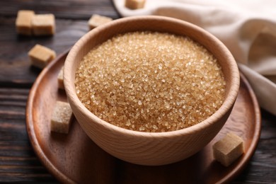 Photo of Brown sugar in bowl on table, closeup