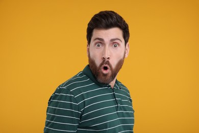 Photo of Portrait of surprised man on yellow background