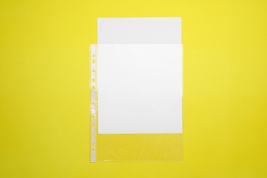 Punched pockets on yellow background, top view