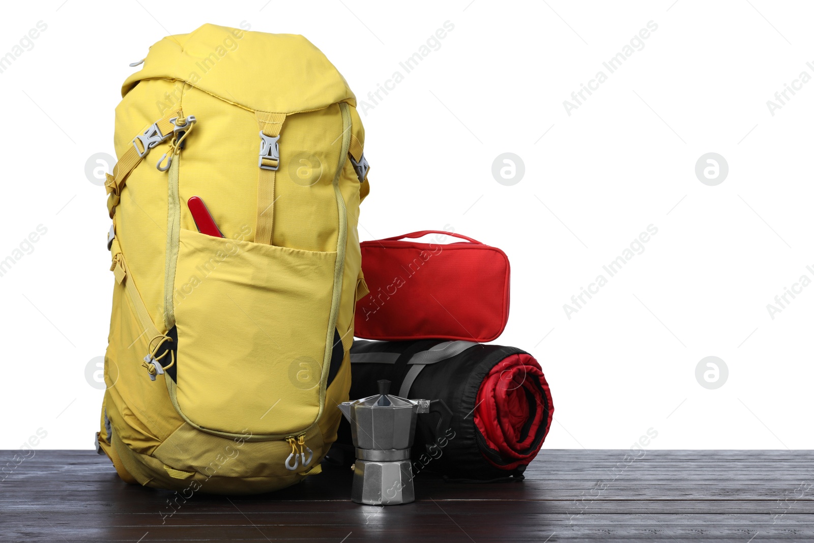 Photo of Set of tourist equipment on wooden surface against white background. Space for text
