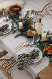 Christmas table setting with festive decor and dishware indoors