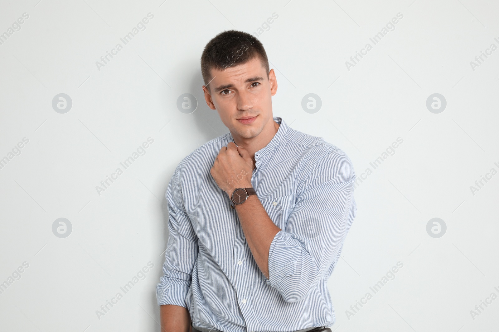 Photo of Portrait of handsome young man on light background