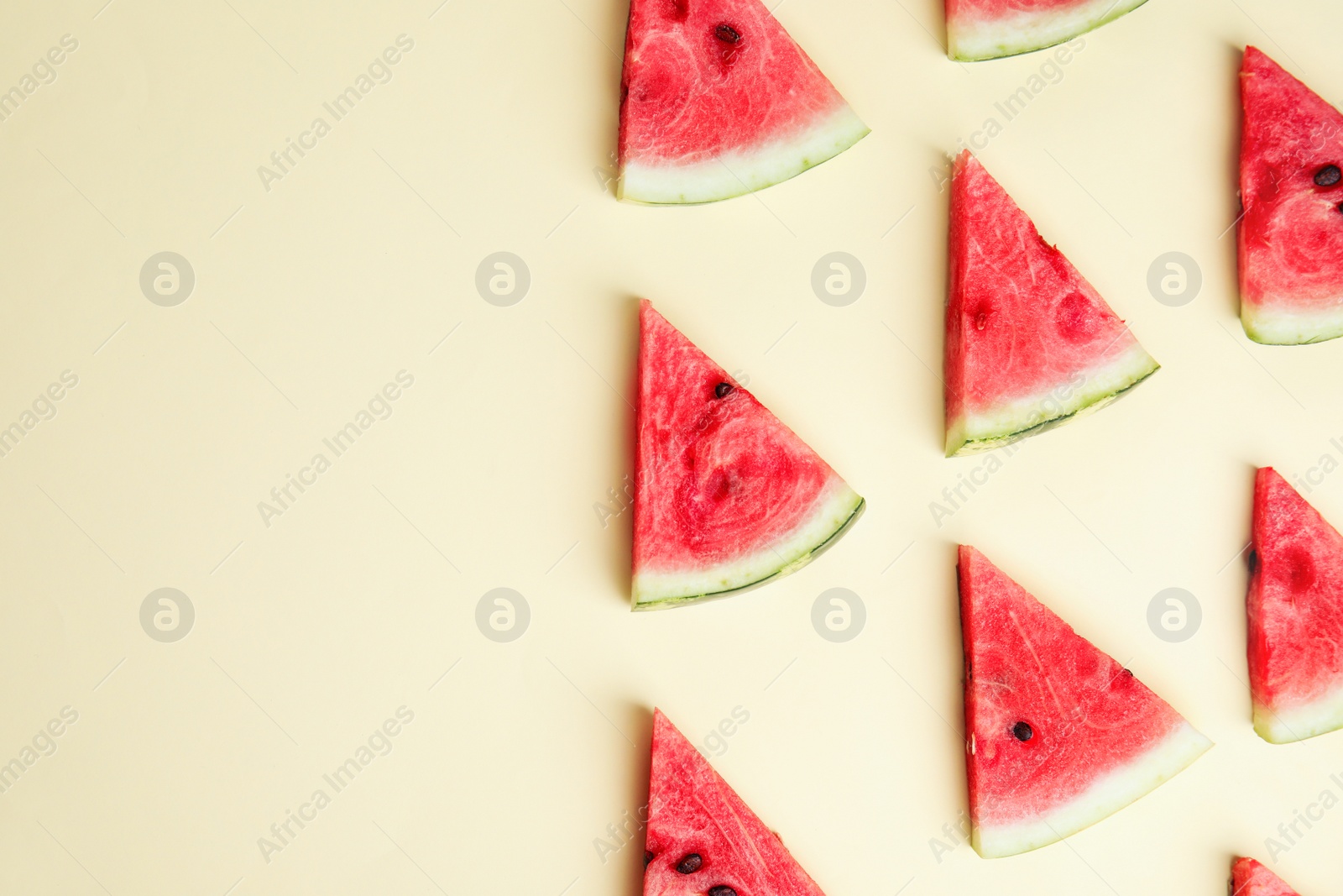 Photo of Slices of ripe watermelon on beige background, flat lay. Space for text