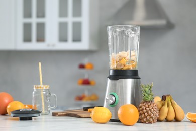 Photo of Blender with smoothie ingredients on white marble table. Space for text