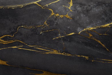 Image of Beautiful black and gold marble surface as background