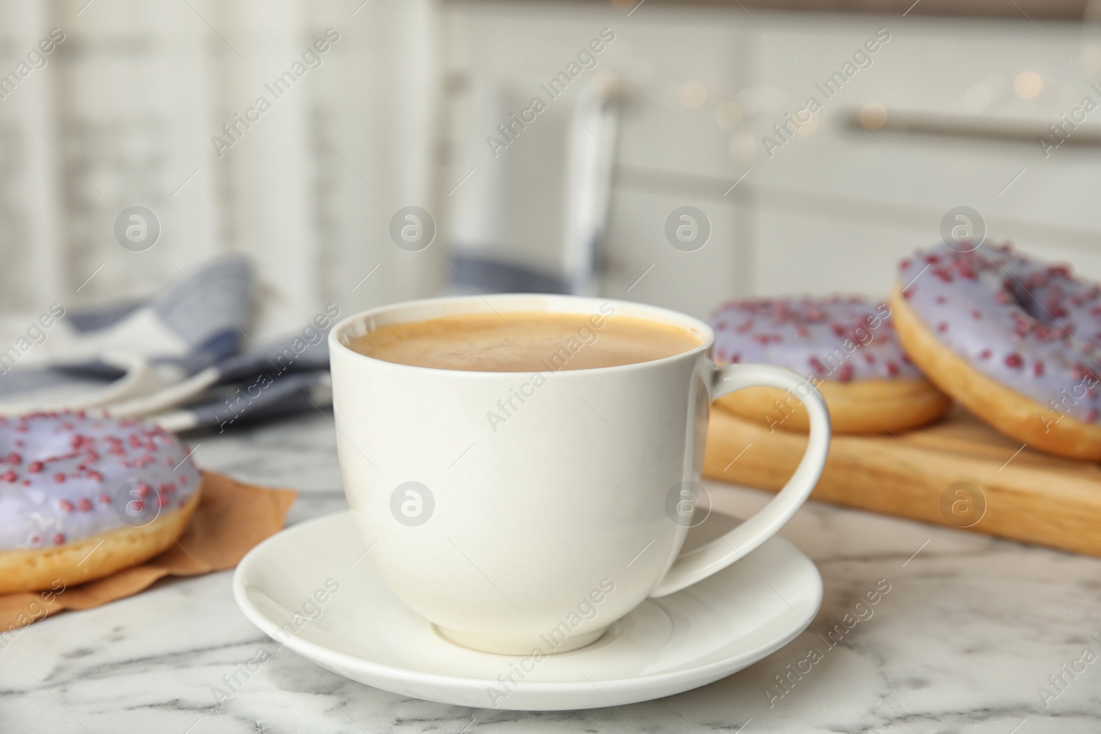 Photo of Delicious coffee and pastries on marble table