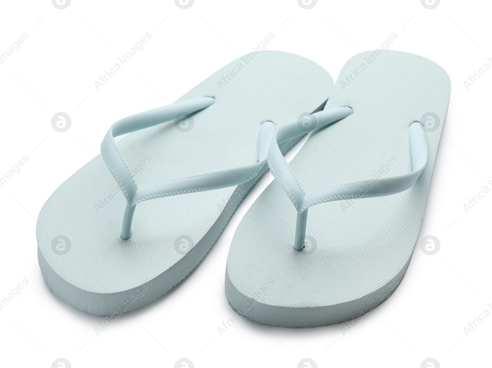 Photo of Stylish light blue flip flops on white background. Beach object