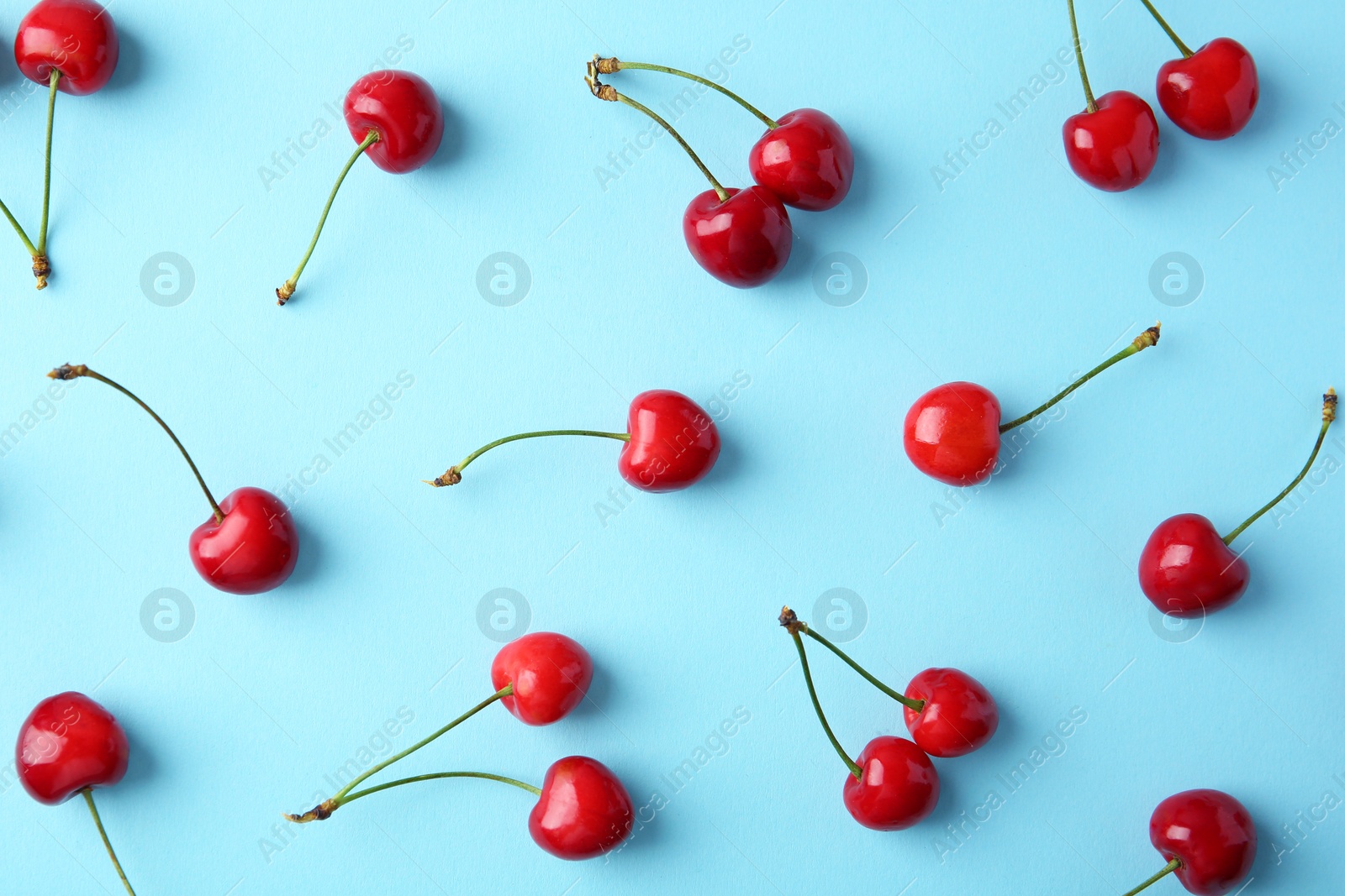 Photo of Ripe red cherries on color background, top view