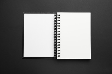 Photo of One notebook on black background, top view