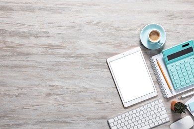 Photo of Flat lay composition with modern tablet on white wooden table. Space for text