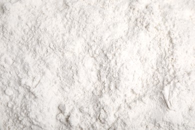 Photo of Pile of wheat flour as background, top view