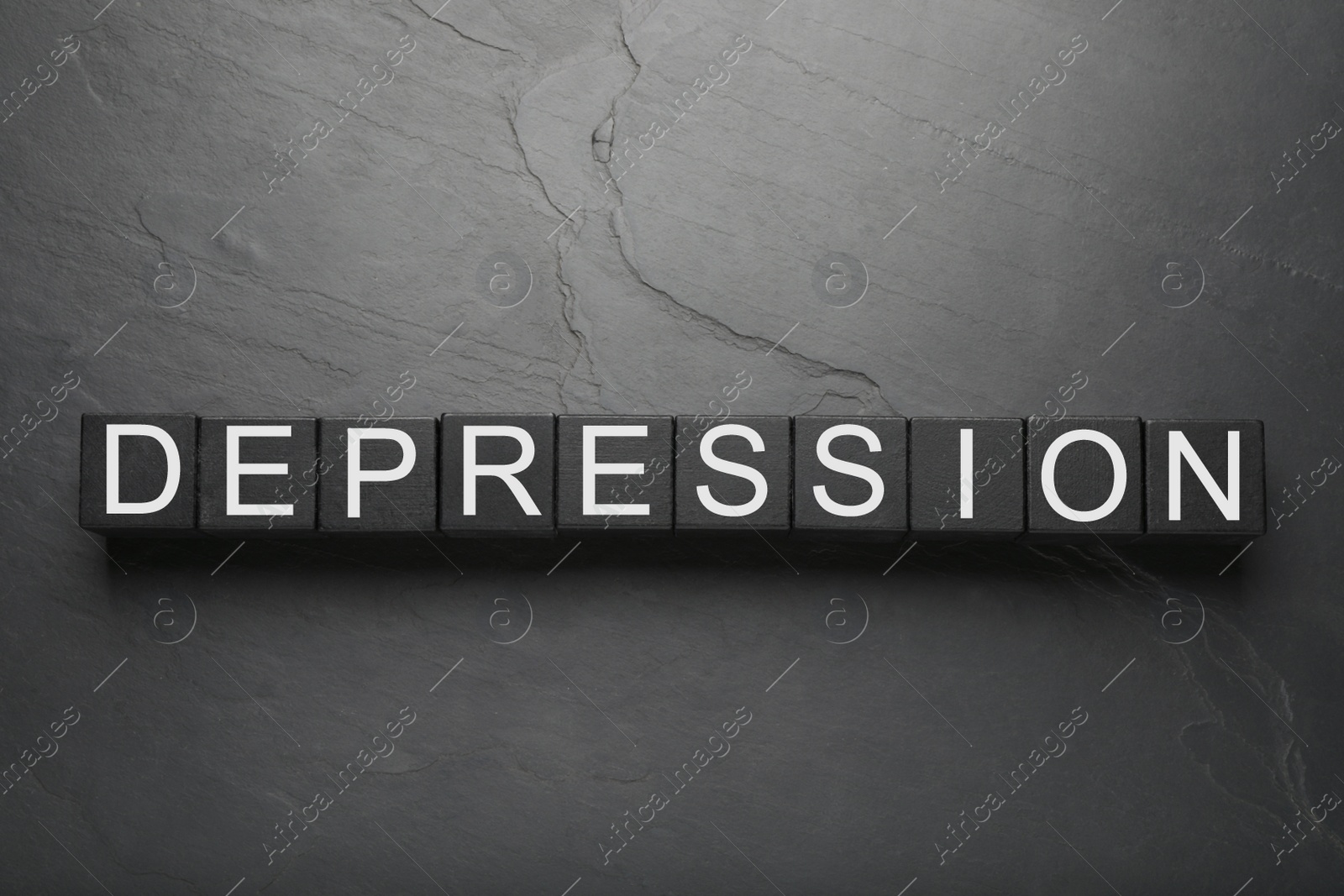 Photo of Word Depression made of black wooden cubes on dark table, flat lay