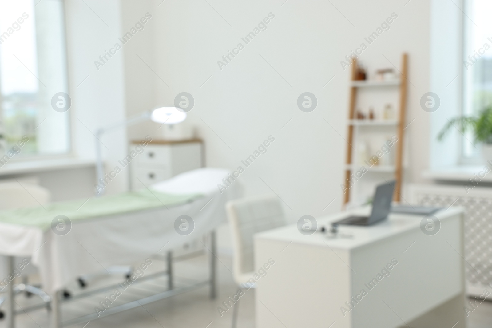 Photo of Modern interior of dermatologist's office with examination table