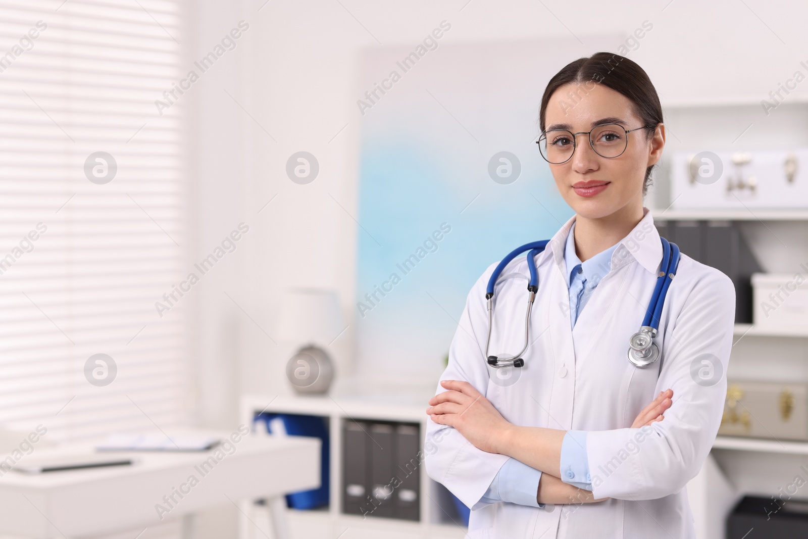 Photo of Medical consultant with glasses and stethoscope in clinic, space for text