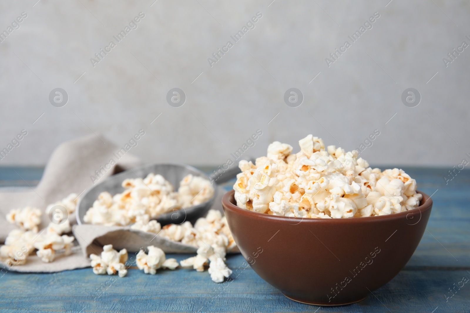 Photo of Tasty pop corn on blue wooden table