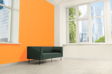 Photo of Beautiful interior with sofa near orange wall