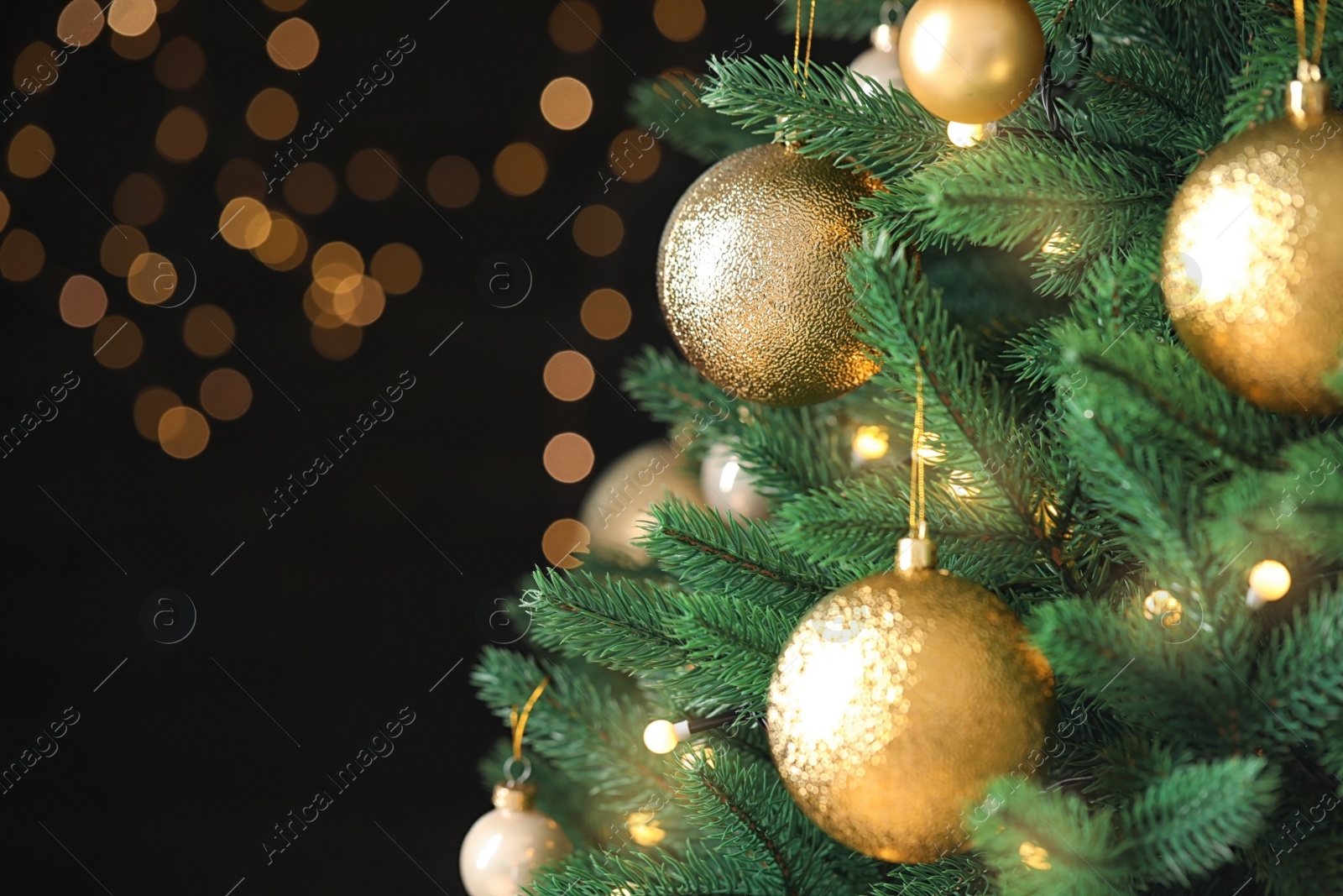 Photo of Beautiful Christmas tree with festive decor against blurred lights on background. Space for text