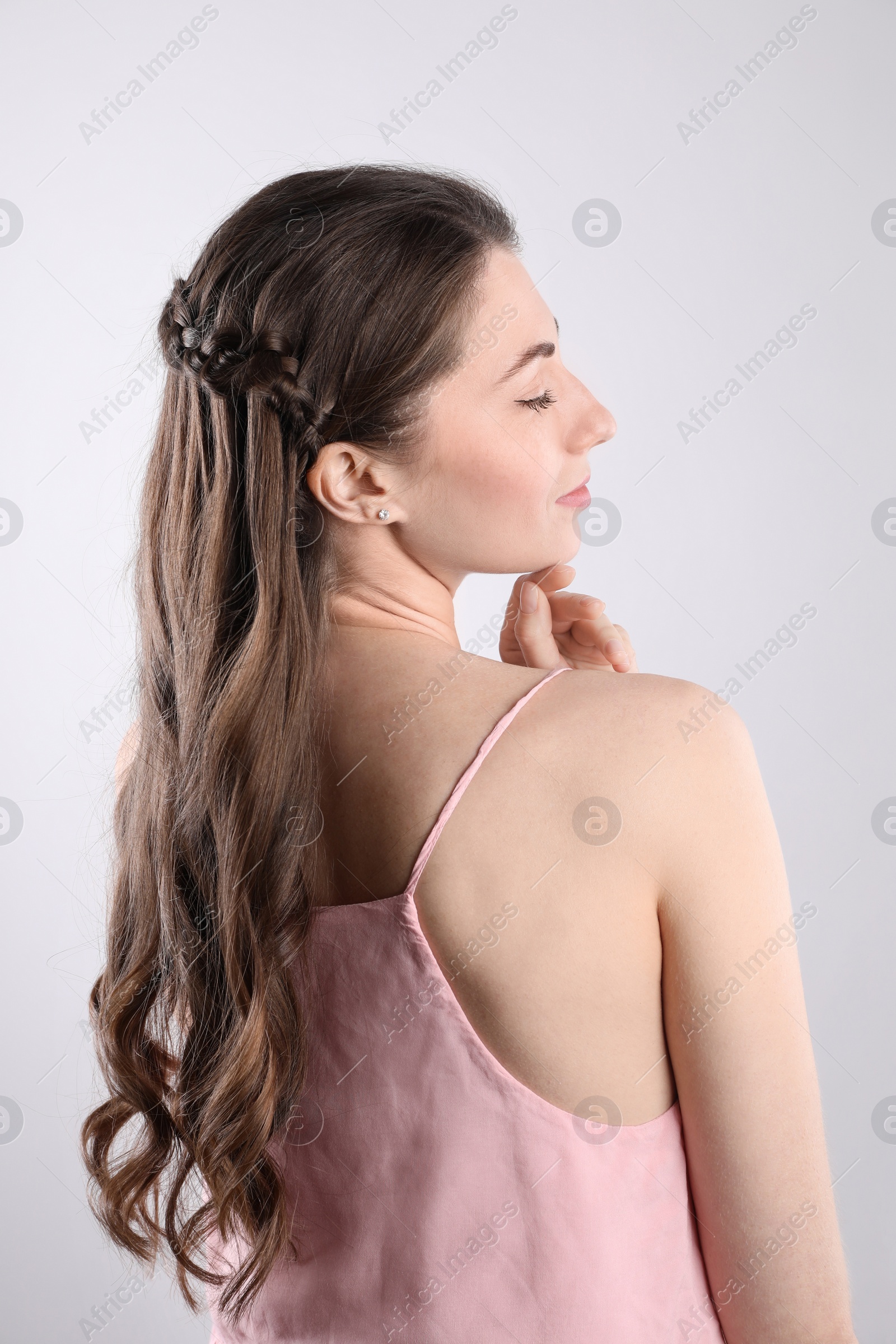 Photo of Woman with braided hair on light background