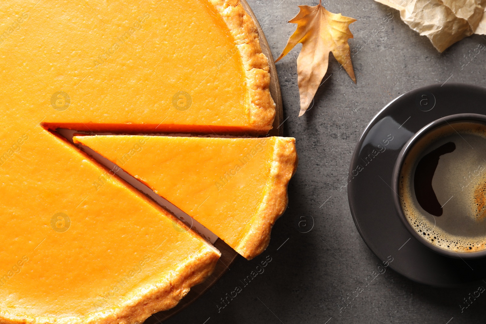 Photo of Flat lay composition with fresh delicious homemade pumpkin pie on table