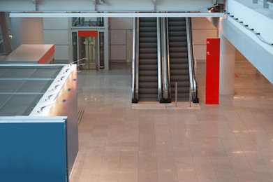 Photo of Interior of new airport terminal with escalators