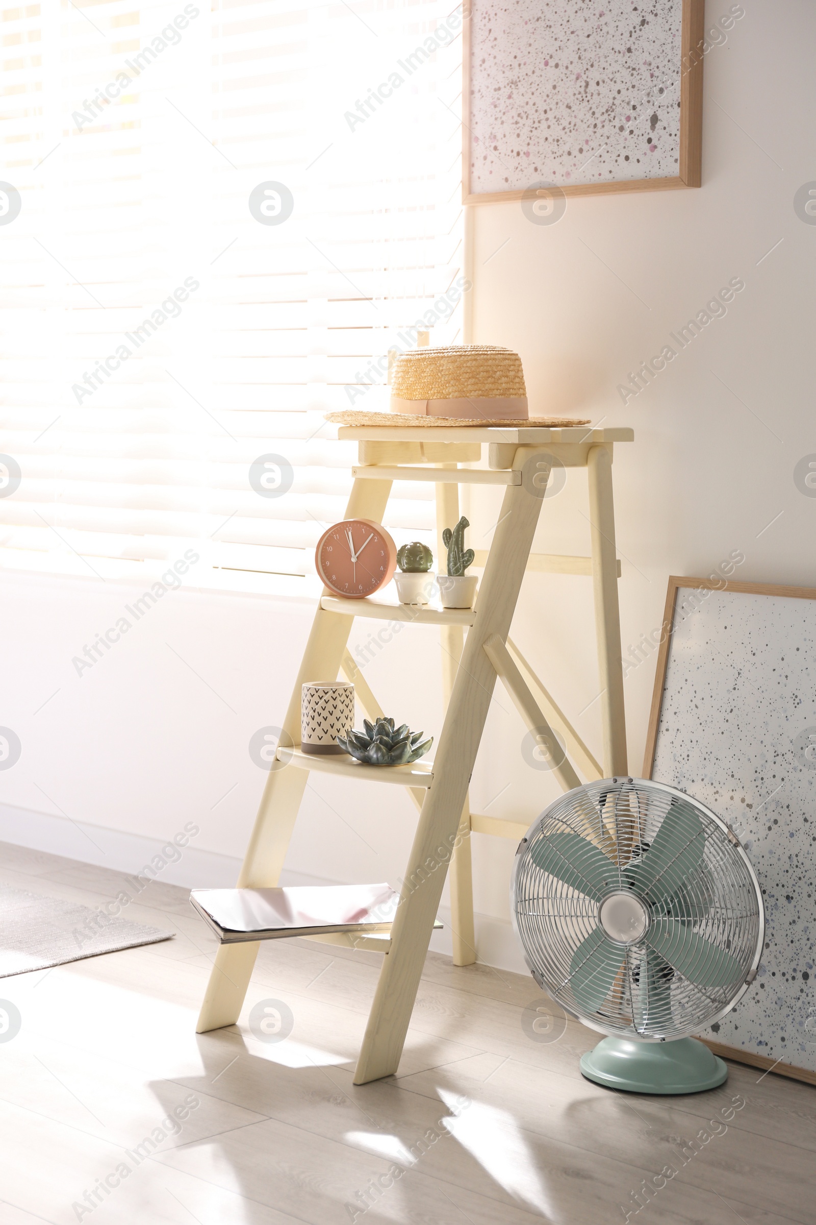 Photo of Decorative ladder with different stuff in stylish bedroom. Idea for interior design