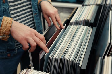 Image of Man choosing vinyl records in store, closeup