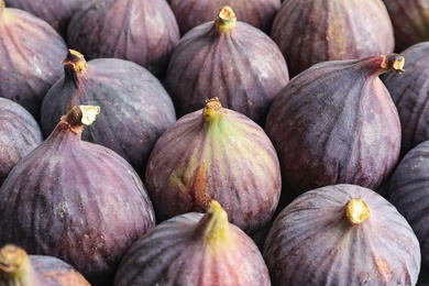 Many whole fresh purple figs as background, closeup