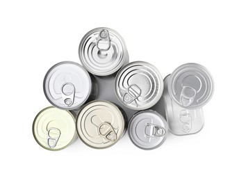 Photo of Many tin cans isolated on white, top view