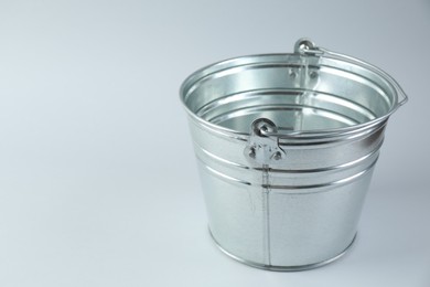 One shiny metal bucket on white background. Space for text