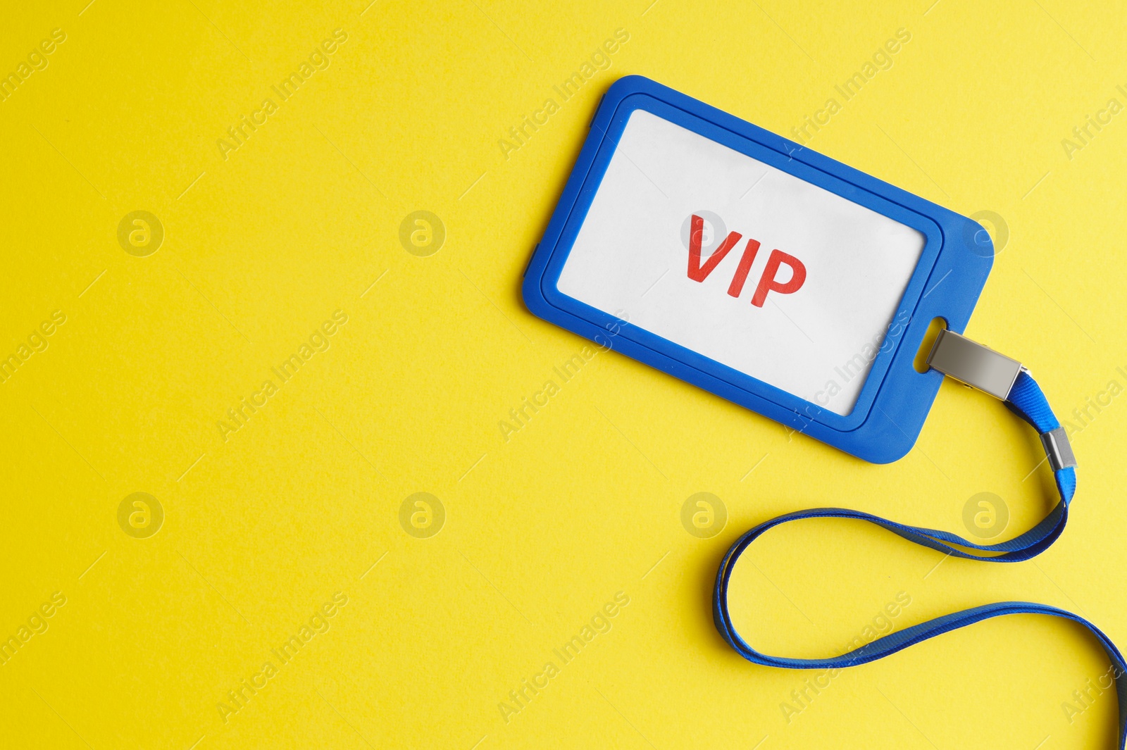 Photo of Vip badge on yellow background, top view. Space for text