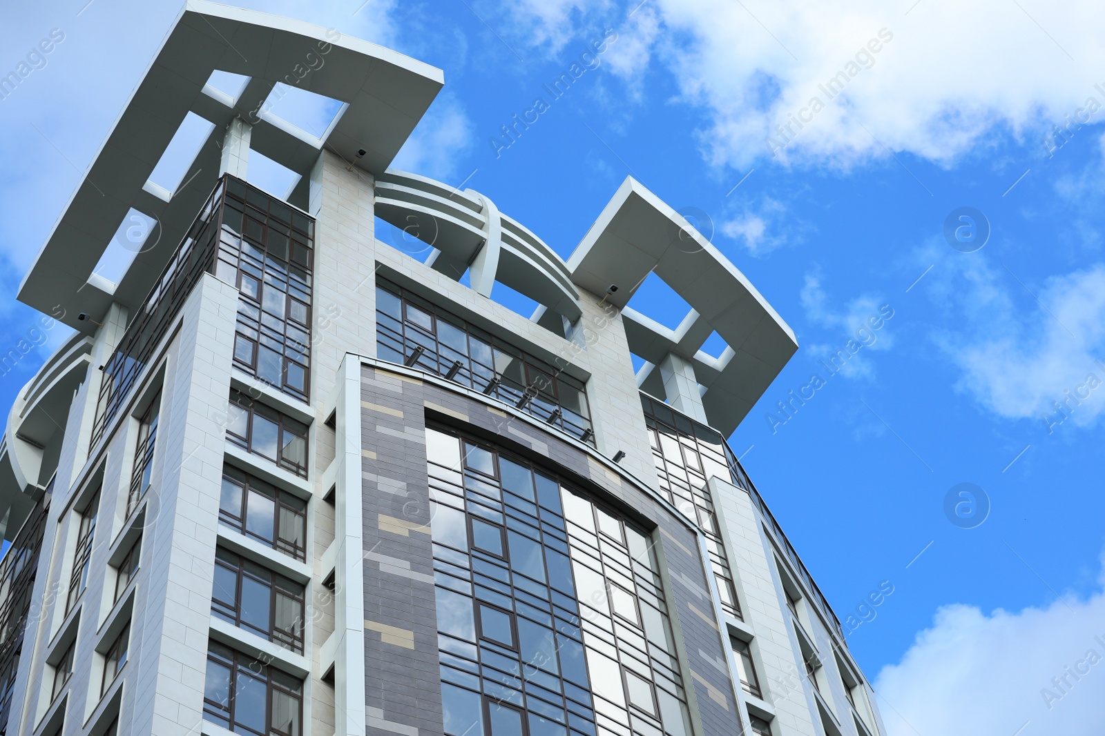 Photo of Low angle view of modern building against blue sky