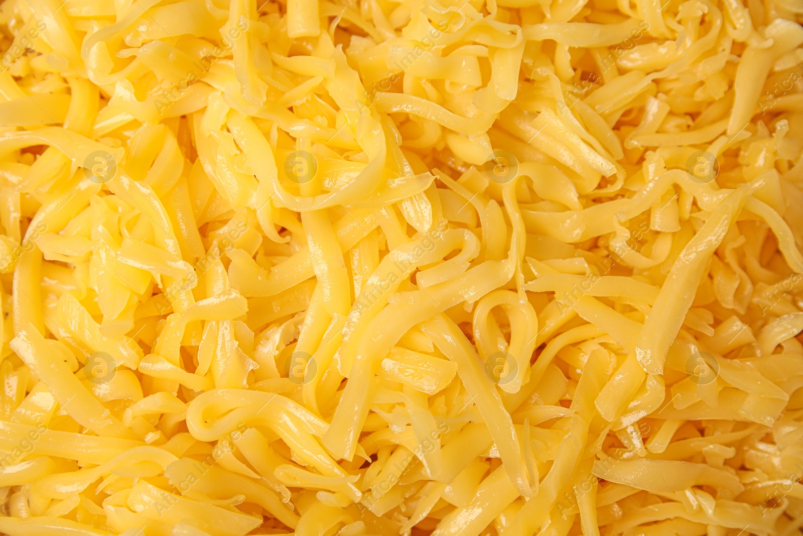 Photo of Delicious grated cheese as background, top view