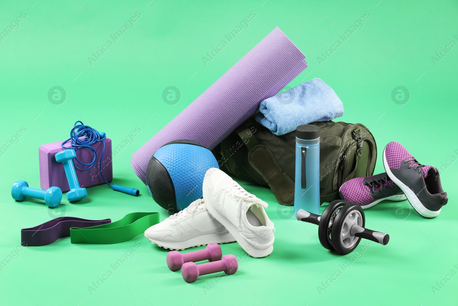 Photo of Many different sports equipment on green background