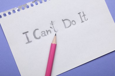 Photo of Motivation concept. Paper with changed phrase from I Can't Do It into I Can Do It by erasing letter T on violet background, top view