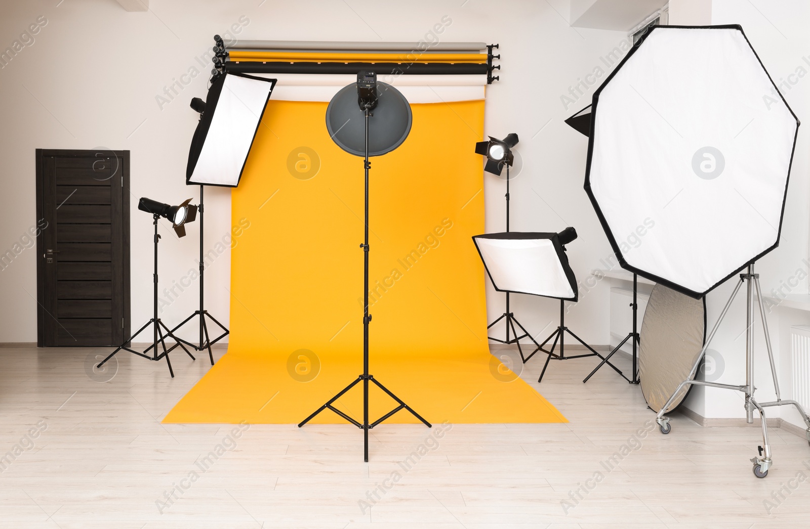 Photo of Interior of modern photo studio with professional lighting equipment