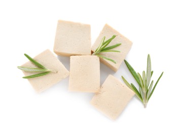 Photo of Delicious tofu and rosemary on white background, top view