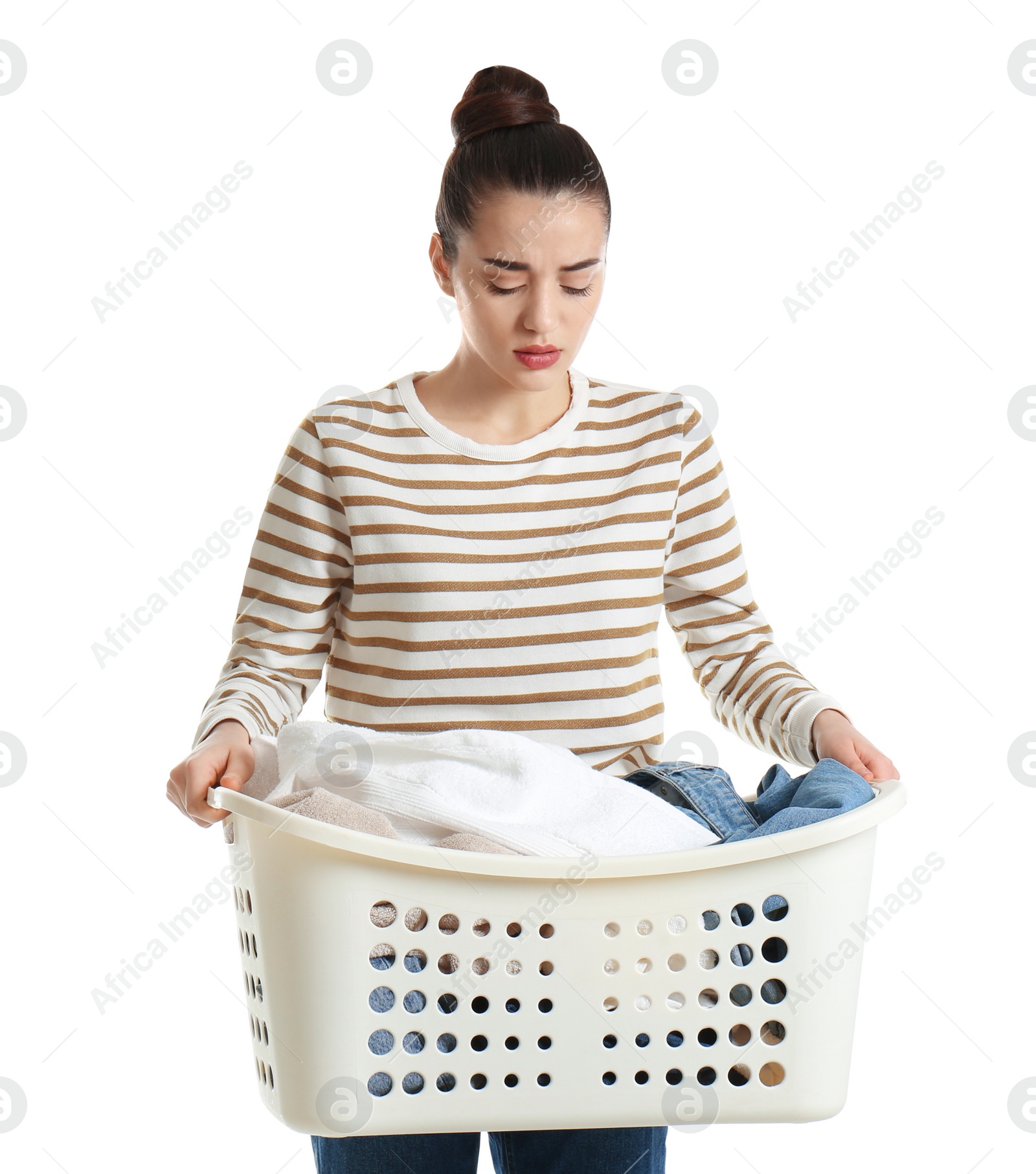 Photo of Displeased young woman holding basket with laundry on white background