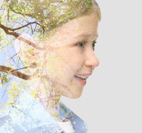 Double exposure of cute little girl and green tree on light background