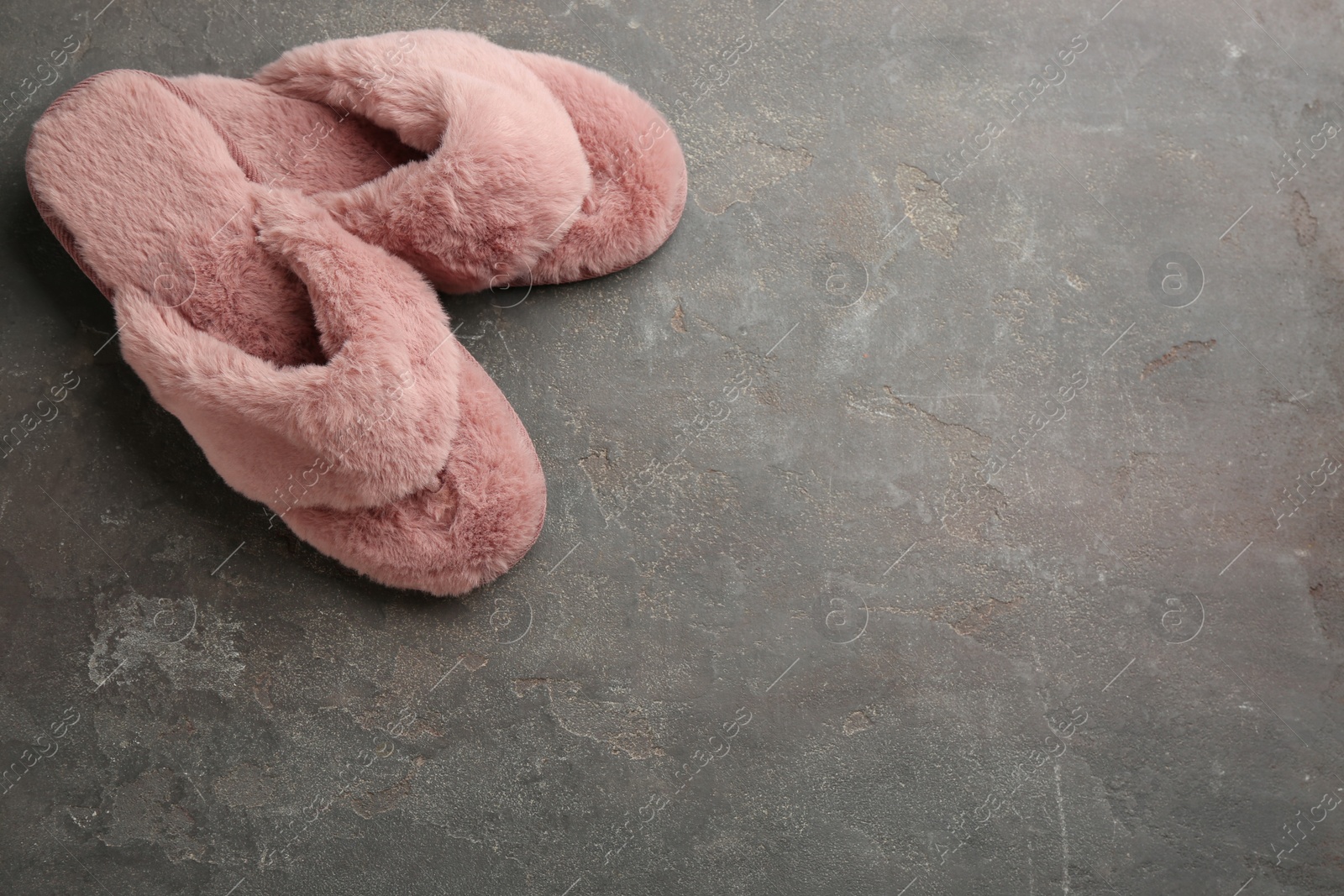 Photo of Pair of stylish soft slippers on grey background, flat lay. Space for text