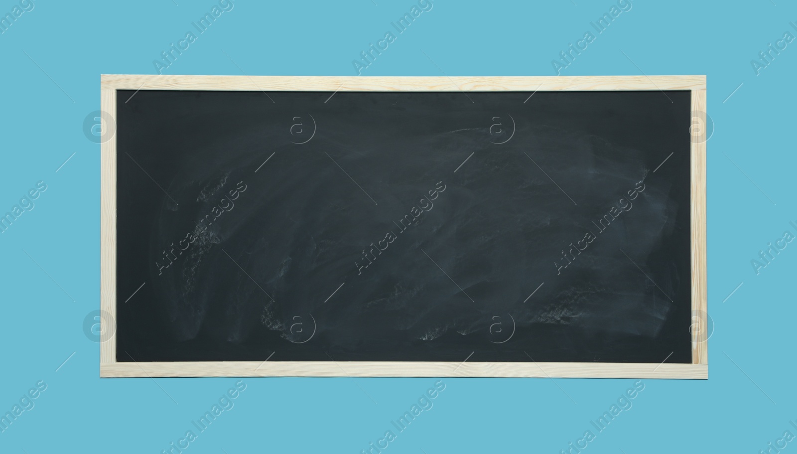 Photo of Dirty black chalkboard on light blue background
