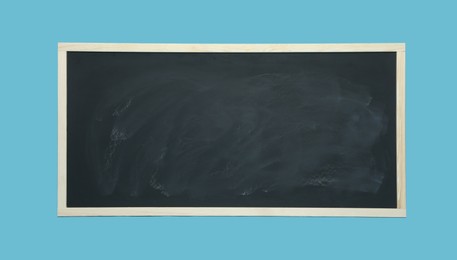 Dirty black chalkboard on light blue background