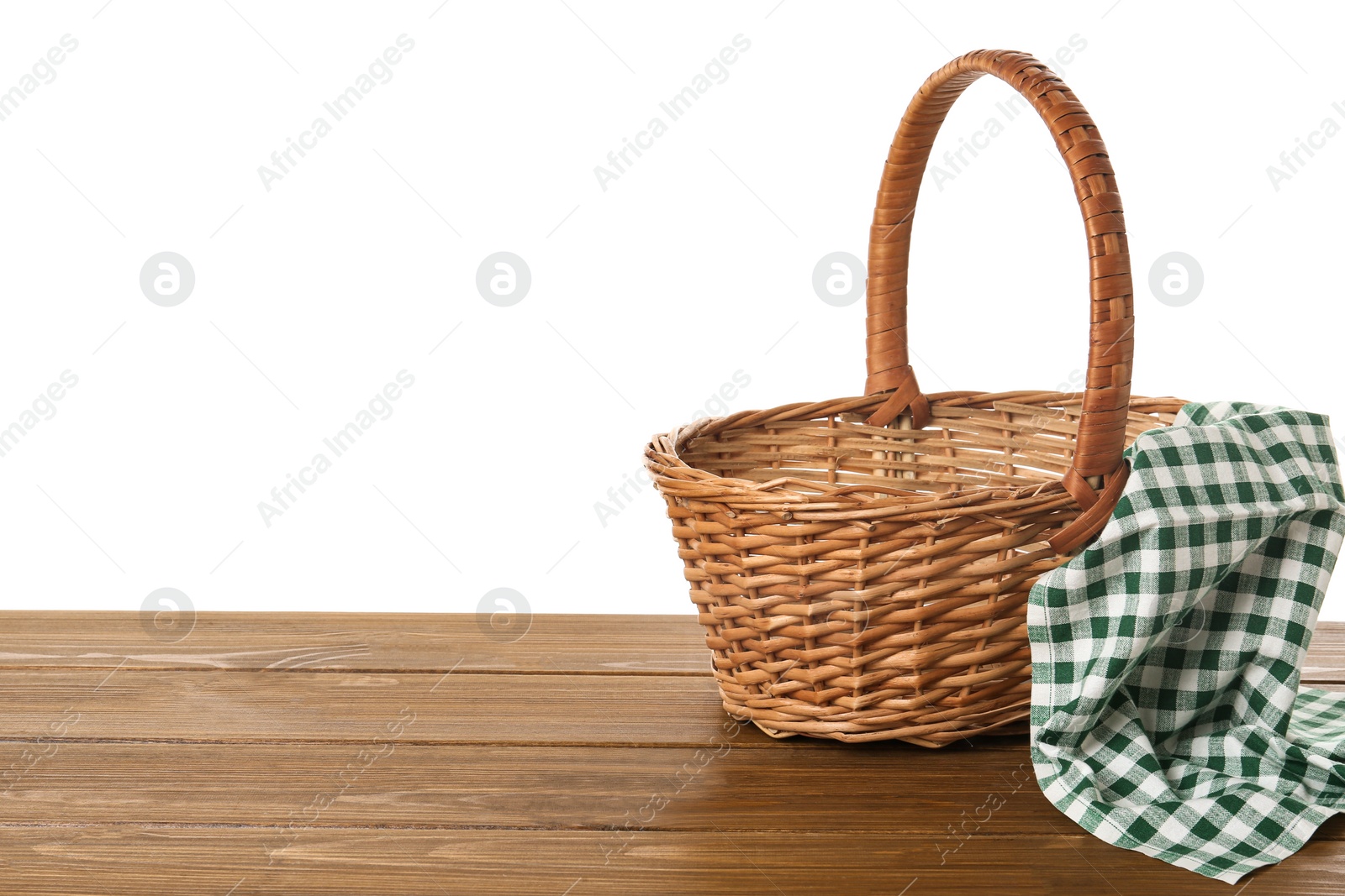 Photo of Wicker basket and towel on wooden table against white background, space for text. Easter item