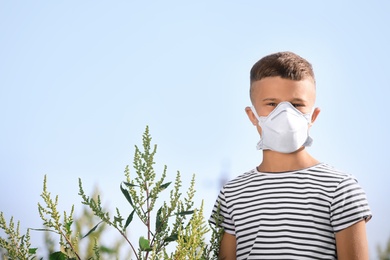 Photo of Little boy suffering from ragweed allergy outdoors