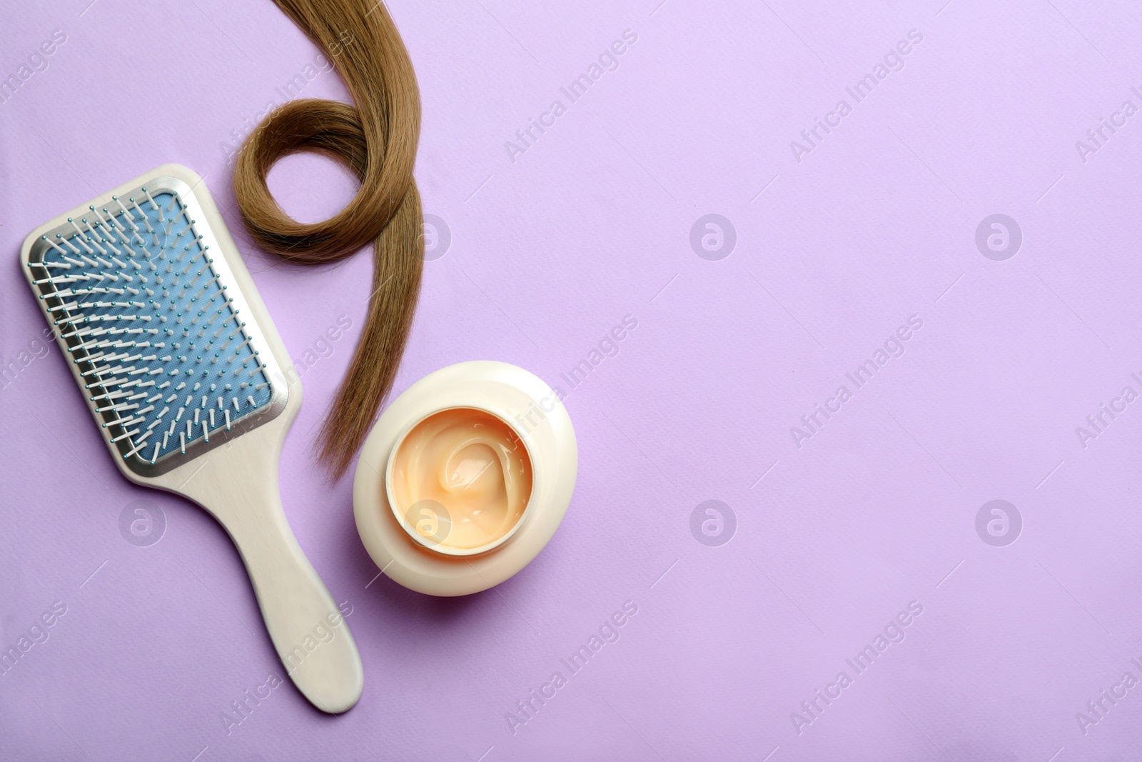 Photo of Jar of cosmetic product, brush and hair lock on violet background, flat lay. Space for text