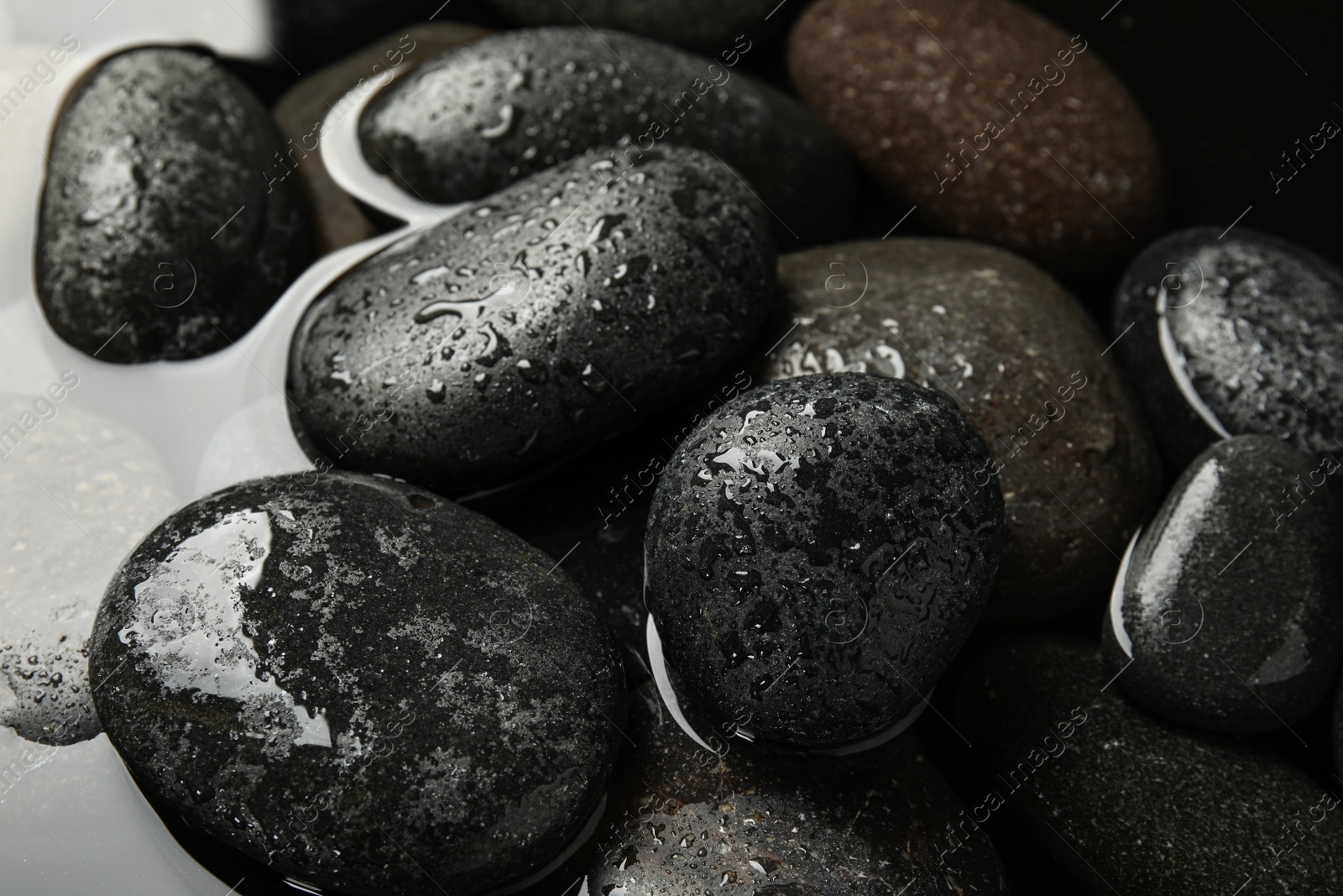 Photo of Pile of stones in water as background, closeup. Zen lifestyle