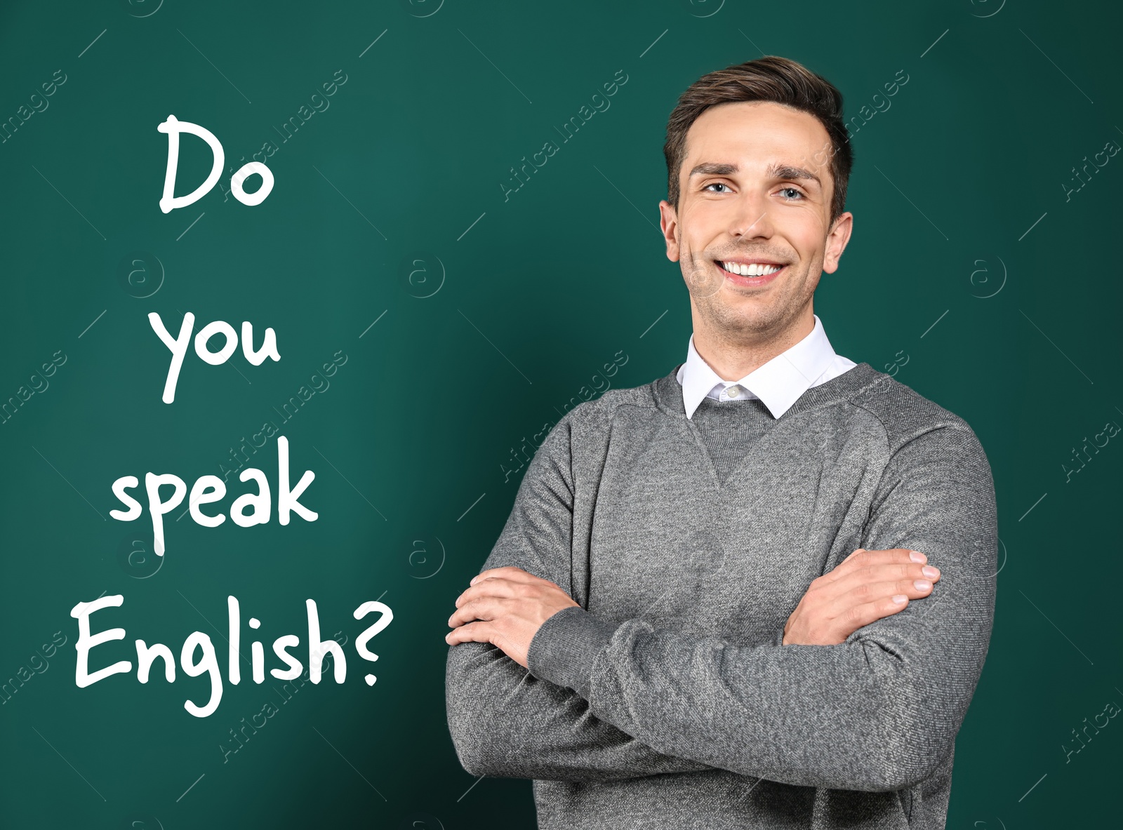 Image of Young teacher near chalkboard with question DO YOU SPEAK ENGLISH